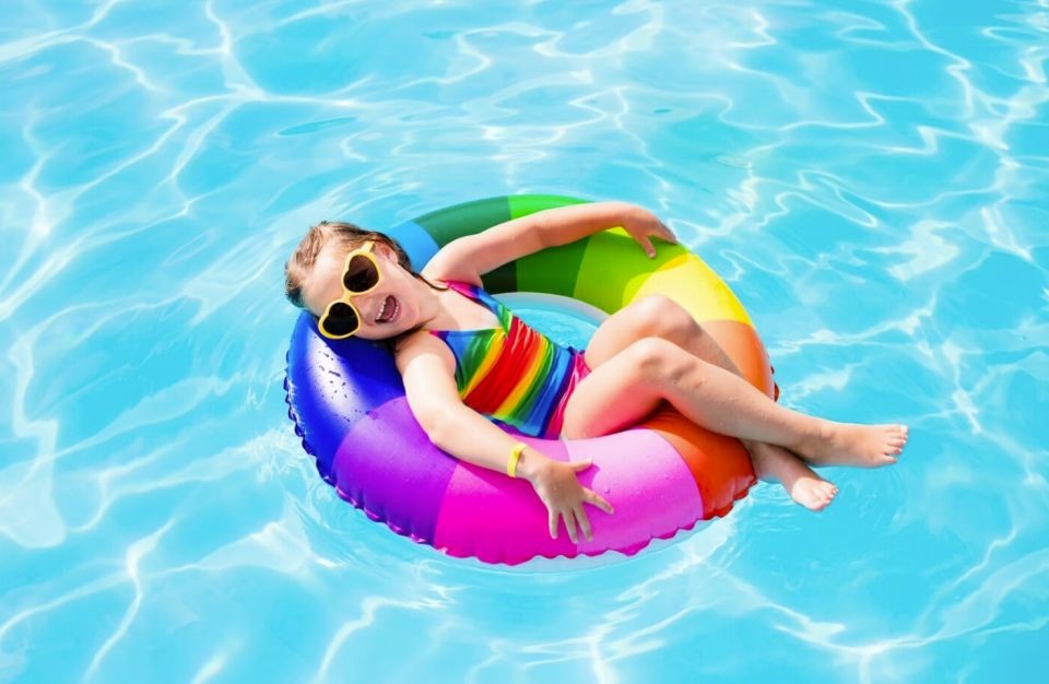 Image of child having fun with a pool ring